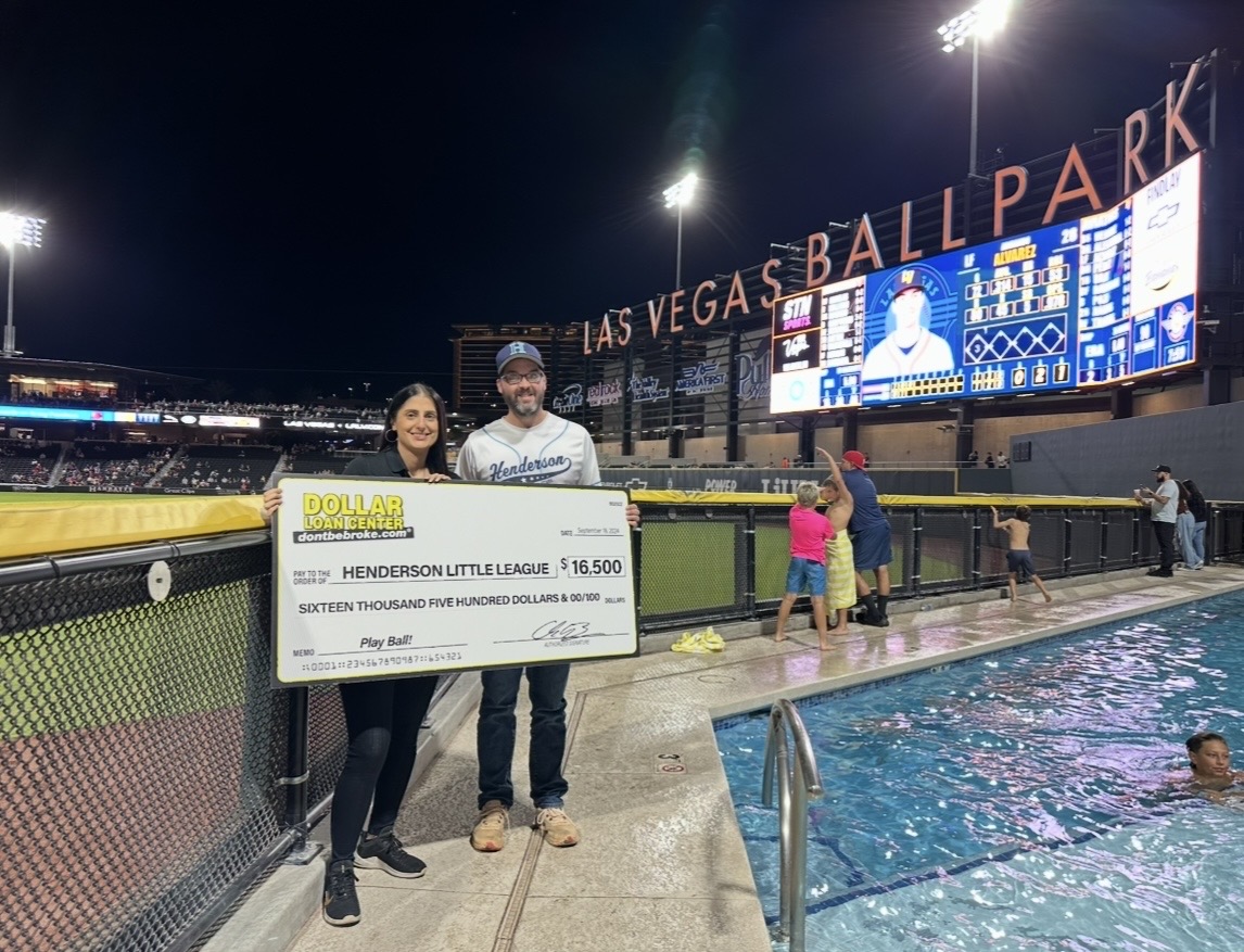 Tayla Polia presenting a donation check to Henderson Little League at Las Vegas Ballpark